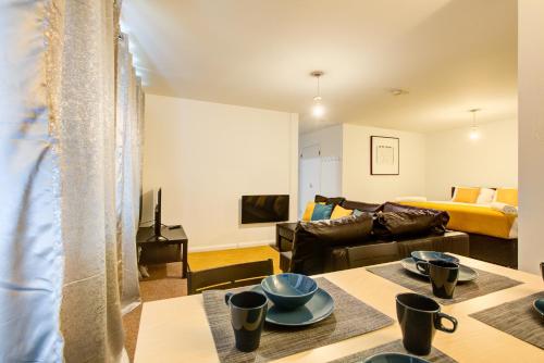 a living room with a couch and a table at Town Centre Apartment in Croydon