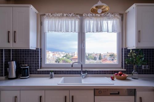 a kitchen with a sink and a window at Gurel Garden House in Kucukkuyu