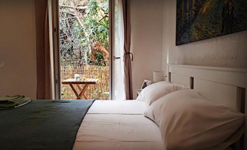 a bedroom with a bed and a large window at Bonaca Apartments in Budva