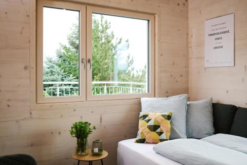 a bedroom with a bed and a window at Ferienwohnung HolzGenuss in Lehrberg