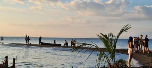 a group of people standing on the beach at Hospedaje y Restaurante la cocina de Mami in Moyogalpa