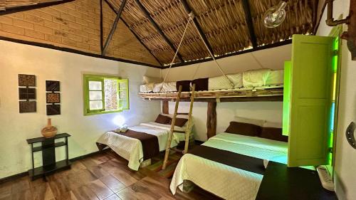 a bedroom with two bunk beds in a room at Hotel Campestre mirador CaloPala in Machetá