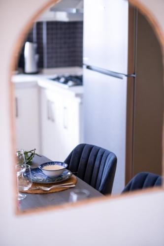 a kitchen with a table and a white refrigerator at Gurel Garden House in Kucukkuyu
