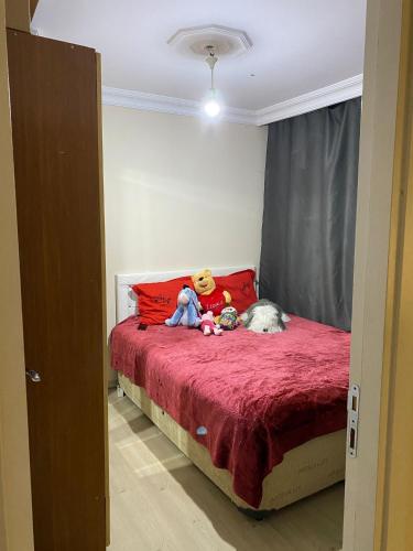a teddy bear and stuffed animals sitting on a bed at TAV in Çekme