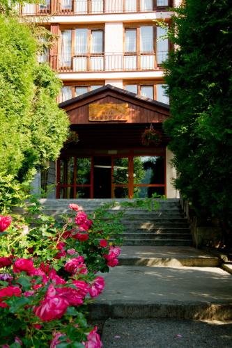 a building with stairs and flowers in front of it at Ośrodek Wczasowy PANORAMA Szczyrk in Szczyrk
