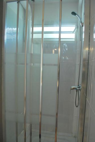 a shower with a glass door in a bathroom at La Dicossine - La Guadeloupe au naturel ;) in Les Abymes