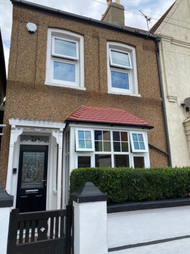 a house with a black fence in front of it at Cosy 2 Bedroom House -2023, 2024 &2025 award winner! in Ramsgate