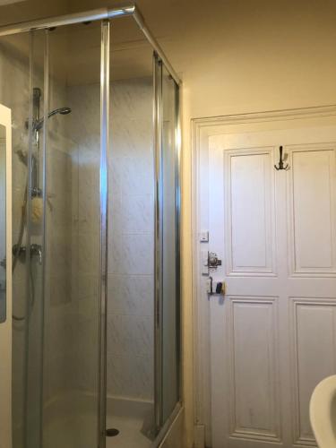 a shower with a glass door in a bathroom at Appartement montagne Le Revard in Pugny-Chatenod
