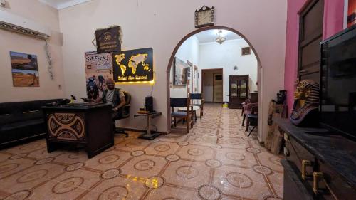 a man sitting in a room with a mirror at Safari Abu Simbel in Abu Simbel