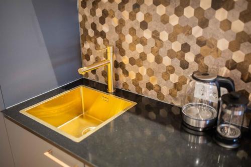 a kitchen counter with a yellow sink in a kitchen at Luxurious 35m2 Designer Studio - R51A in Eindhoven