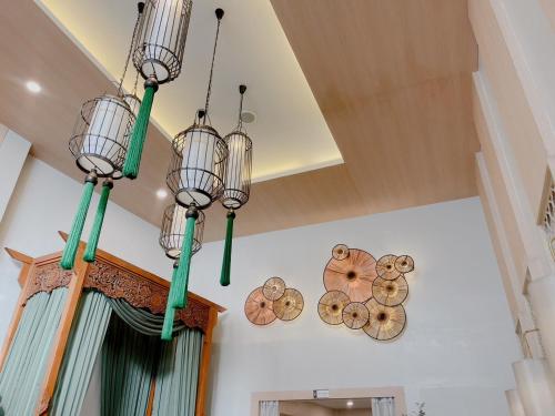a group of chandeliers hanging from a ceiling at Nama Hostel Chiangmai in Chiang Mai