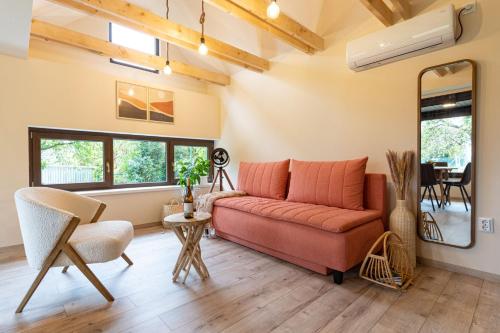 a living room with a couch and a table at HeLo Bungalow in Badacsonytördemic