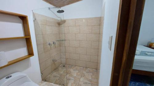 a bathroom with a shower with a toilet at Casa THIREMA Tortuguero in Tortuguero
