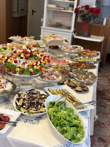 a buffet with many plates of food on a table at Hotel Morolli in Rimini
