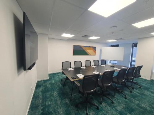 a conference room with a long table and chairs at La Quinta by Wyndham Ellerslie Auckland in Auckland