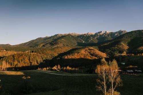 a view of a golf course in the mountains at Matca Hotel Relais & Châteaux in Şimon