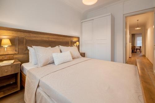 a bedroom with a large white bed with white pillows at Gurel Garden House in Kucukkuyu