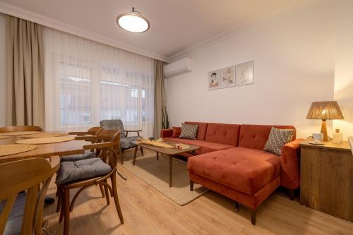 a living room with a couch and a table at Gurel Garden House in Kucukkuyu