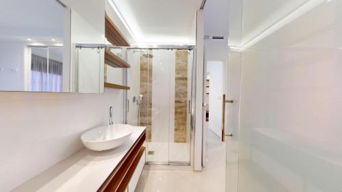 a bathroom with a sink and a shower at Arenales Paradise with Pool AC Balcony and Terrace in Arenales del Sol
