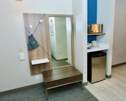 a dressing room with a mirror and a bench at Holiday Inn Express Hotel & Suites St. Charles by IHG in St. Charles