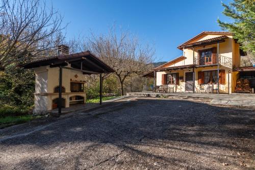 a house with a driveway in front of it at RiverHome in Gávros