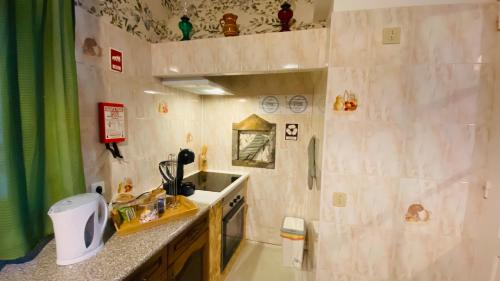 a small bathroom with a sink and a counter at Alojamento CANTO NA RELVA in Ponta Delgada