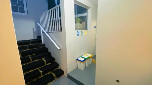 a staircase in a room with a stair case at Alojamento CANTO NA RELVA in Ponta Delgada