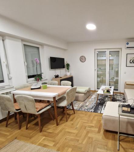 a living room with a table and chairs at Kris apartments in Skopje