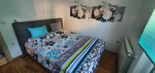 a bed in a bedroom with flowers on it at Kris apartments in Skopje