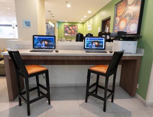 two laptops sitting on a counter in a store at Holiday Inn Express Guadalajara Aeropuerto by IHG in Guadalajara
