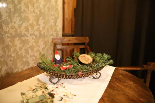 a table with a christmas decoration on top of it at Pirgos Gerodimou in Kalavrita