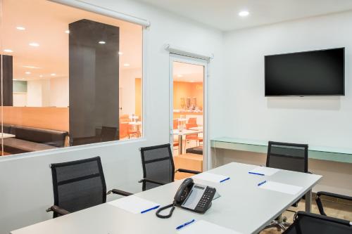 a conference room with a phone on a table at One Irapuato in Irapuato