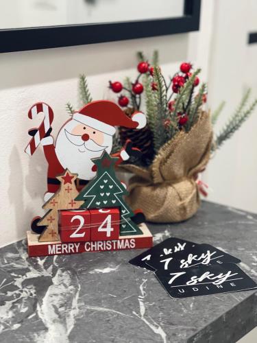 a christmas sign with a santa claus on a table at 7 SKY UDINE in Udine