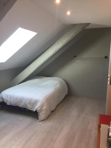 une chambre avec un lit dans un grenier dans l'établissement Studio étage 3, proche Techn'hom, IUT et UTBM, à Belfort