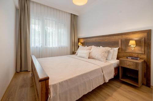 a bedroom with a large bed and a window at Gurel Garden House in Kucukkuyu