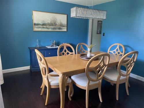 a dining room with a wooden table and chairs at Home with Free Tesla Charger in Christiana in Newark