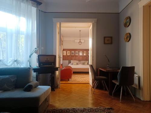 een woonkamer met een bank en een slaapkamer bij Parkside Large Modern Garden View Apartment in Boedapest