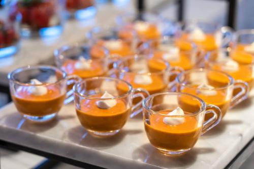 a bunch of cups filled with orange juice on a table at The Ritz-Carlton, Los Angeles L.A. Live in Los Angeles