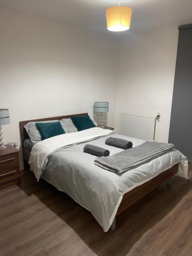 a bedroom with a large bed with blue pillows at Waterside heights Dockland in London