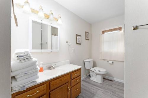 a white bathroom with a sink and a toilet at 3 bedroom duplex by Sanford in Sioux Falls