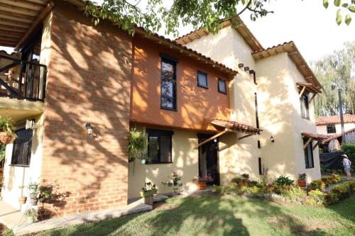 a large house with a lawn in front of it at Villas Panaca Portal 1 in Quimbaya