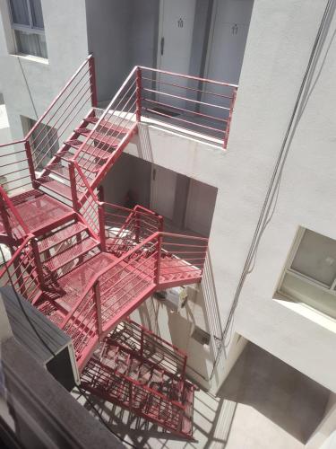 an overhead view of red stairs in a building at Depto en Roca 2 in General Roca