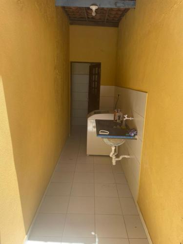 a bathroom with a sink and a bed in a room at Suites na Praia do Francês in Marechal Deodoro