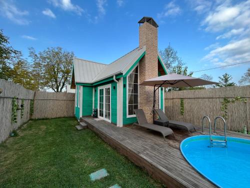a house with a swimming pool next to a fence at WONDERLAND TİNY HOUSE in Sapanca