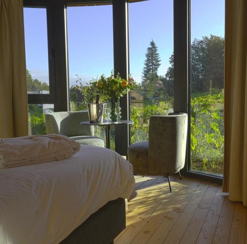 a bedroom with a bed and a table and a window at Cabanes avec jacuzzi les pieds dans la vignes in Incourt