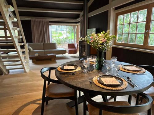 a dining room with a table with chairs and a table at Cabanes avec jacuzzi les pieds dans la vignes 