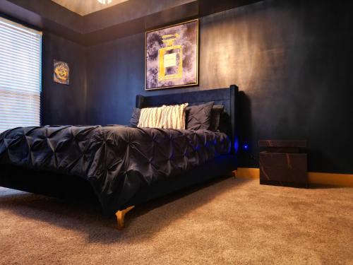 a bedroom with a black bed in a room at live like Royalty in Buckhead in Atlanta