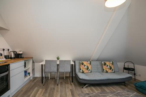 a living room with a couch and a table at ENTR - Modern Apartments in Windsor in Windsor