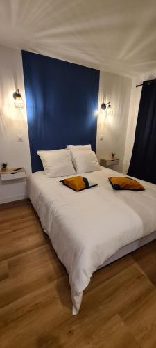 a bedroom with a large white bed with two pillows at Aqua Rêve in Digne-les-Bains