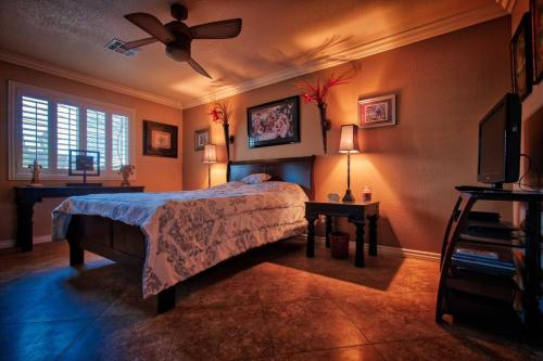 a bedroom with a bed and a ceiling fan at Z House in Las Vegas